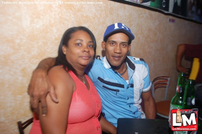 a man and a woman posing together in a restaurant