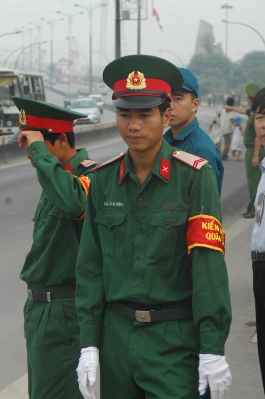 an army man saluting another in his uniform