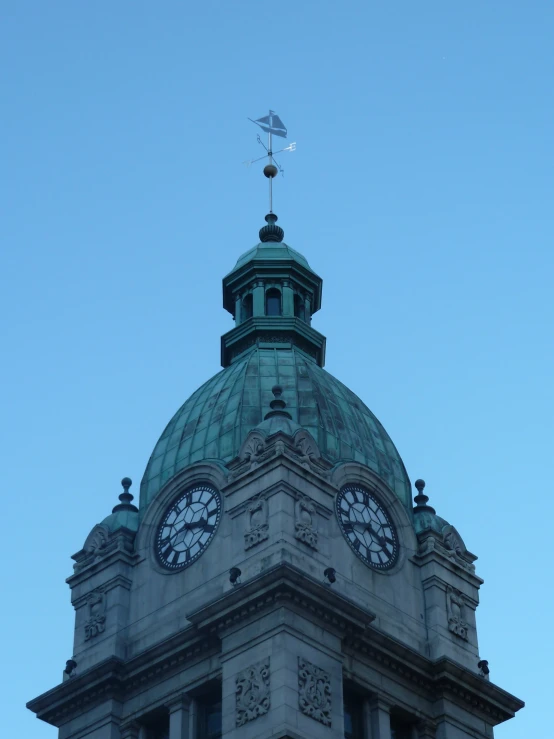 a large gray building with clocks on the side