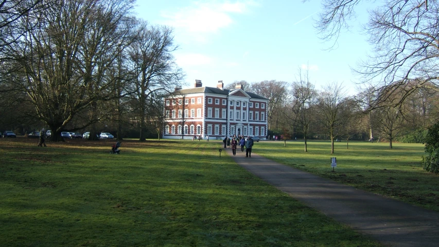 a large brown building with people walking through it