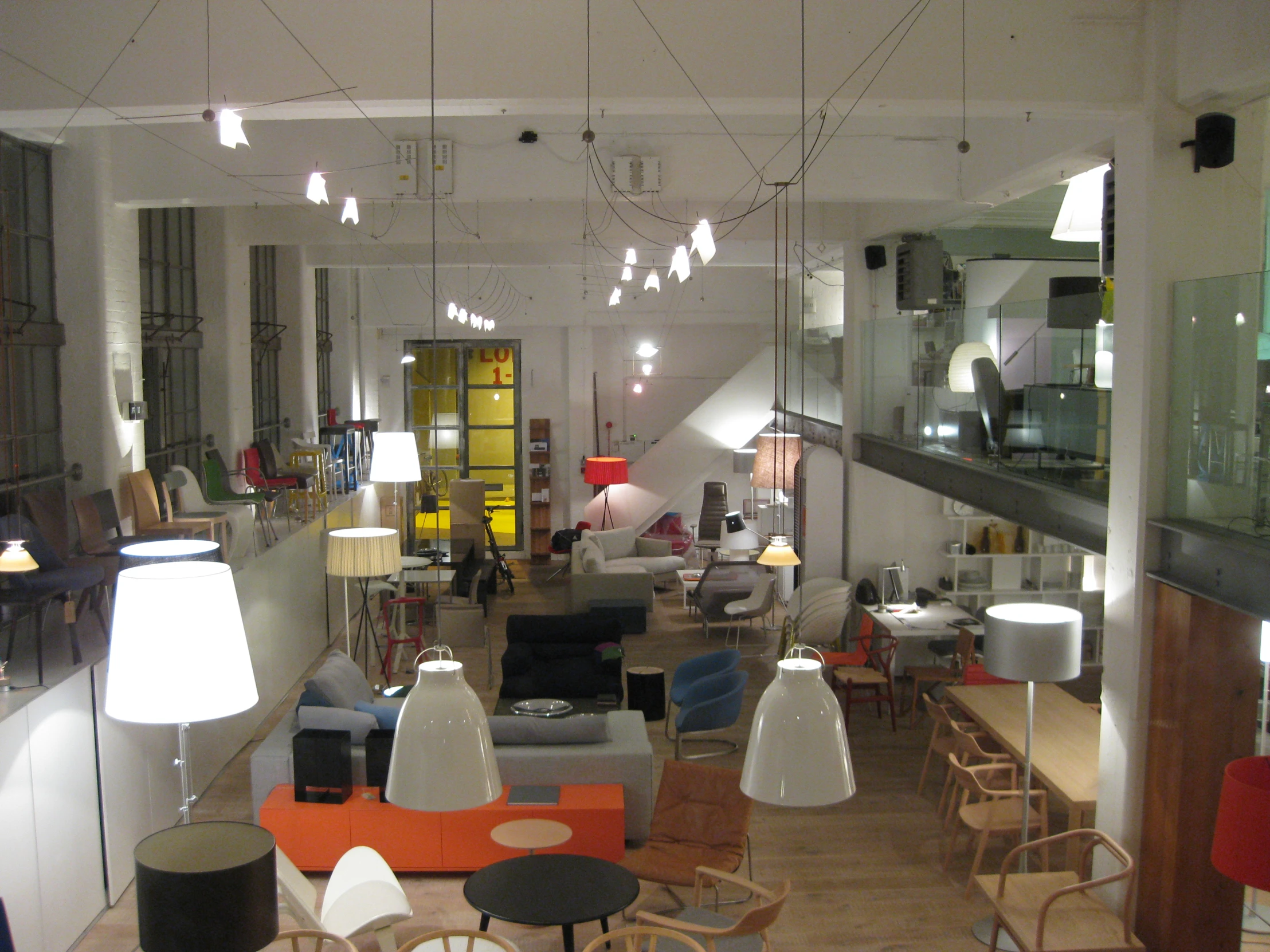 an open store, with large chairs and lamps