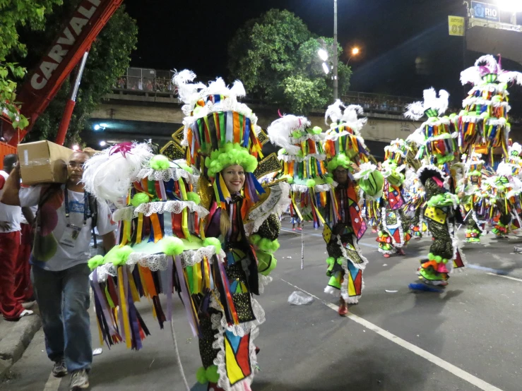 group of people dressed up in clown costumes and headgear