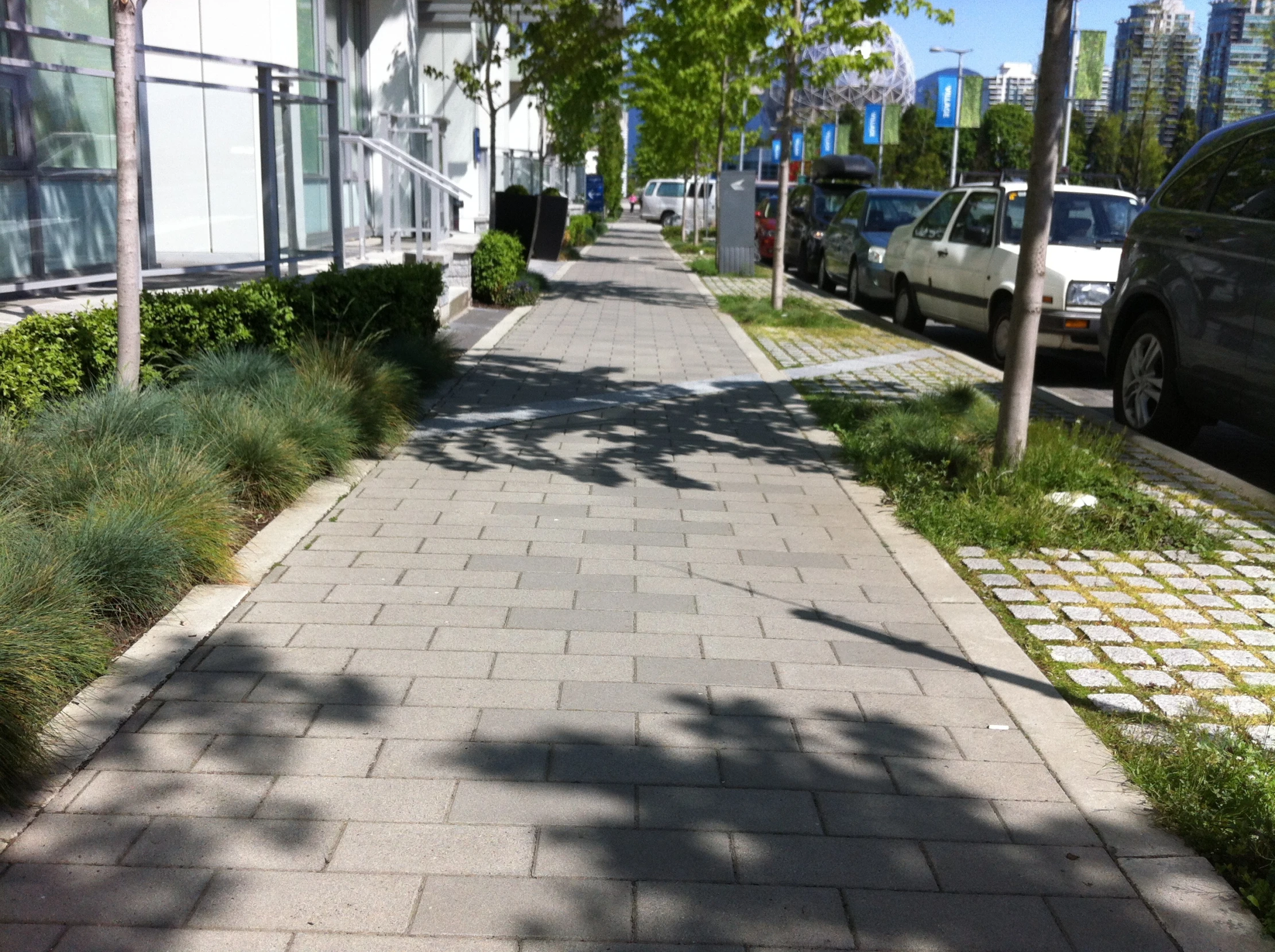 a sidewalk with no vegetation is shown in this urban area