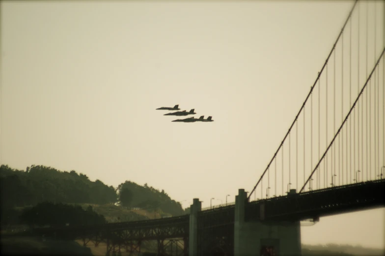 four planes fly in formation in front of the golden gate bridge