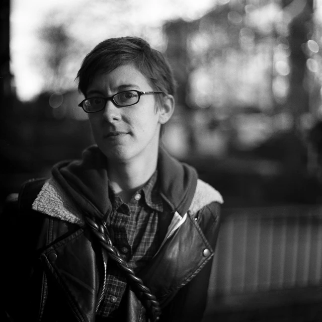 a black and white po of a young man wearing glasses