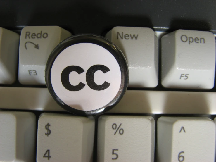 a computer keyboard with the word cc in the center of it