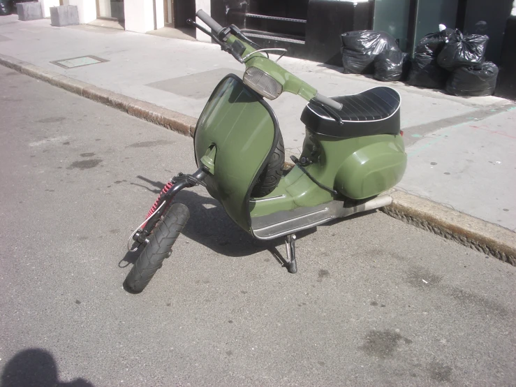 a motor scooter sitting in the middle of the road