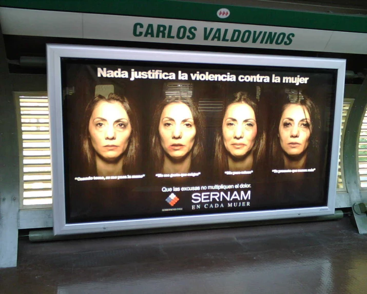 billboard with four different faces, on a subway platform