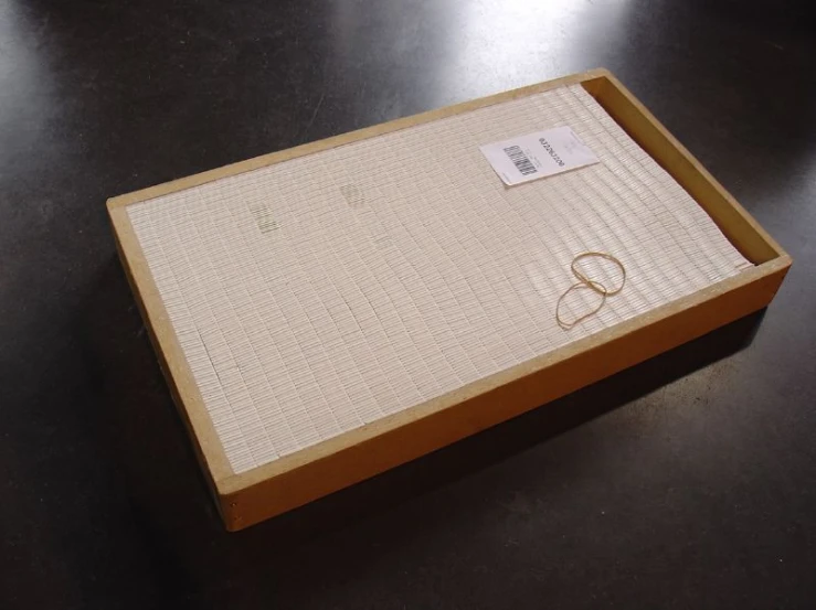 the box with two rings sits on the floor