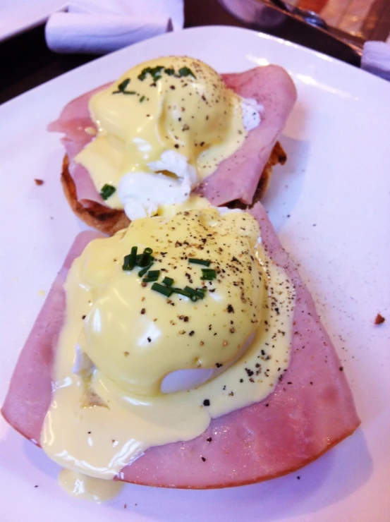 a plate with eggs benedict and ham, on toast