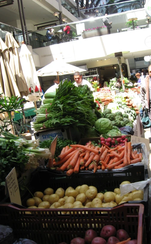 the people are at the market with lots of vegetables