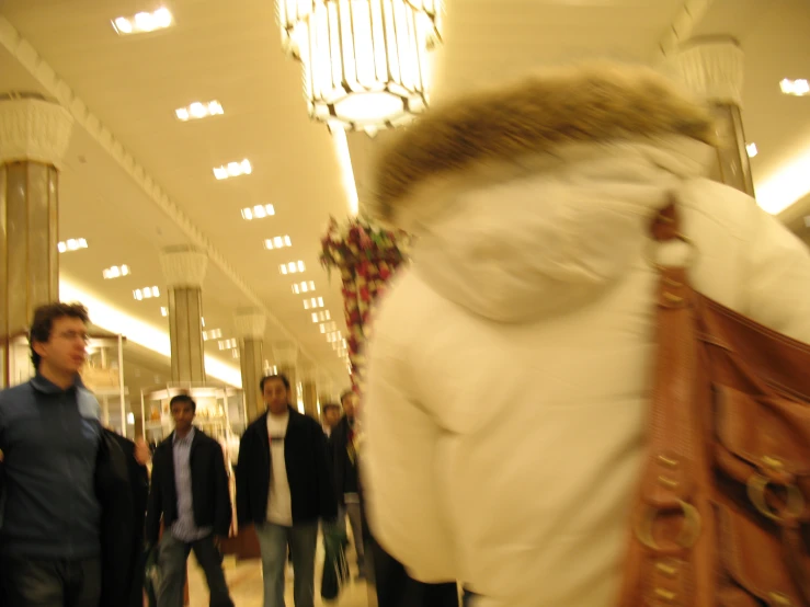 a woman with a purse walks in a store