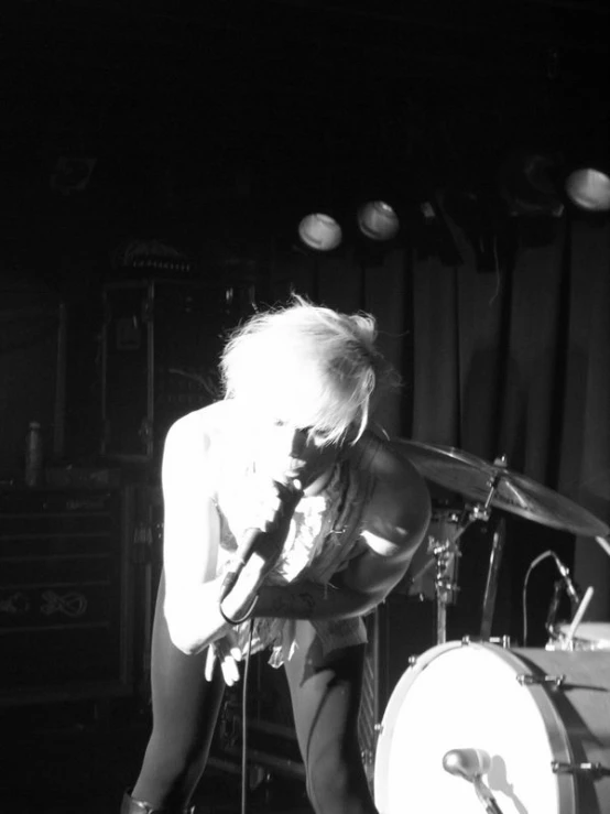 the punk punk girl is playing drums on stage