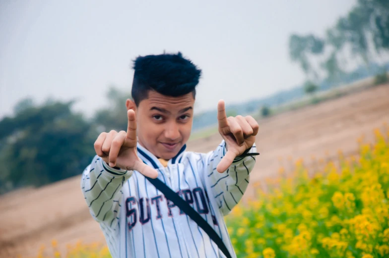 young man holding his hand up in the air