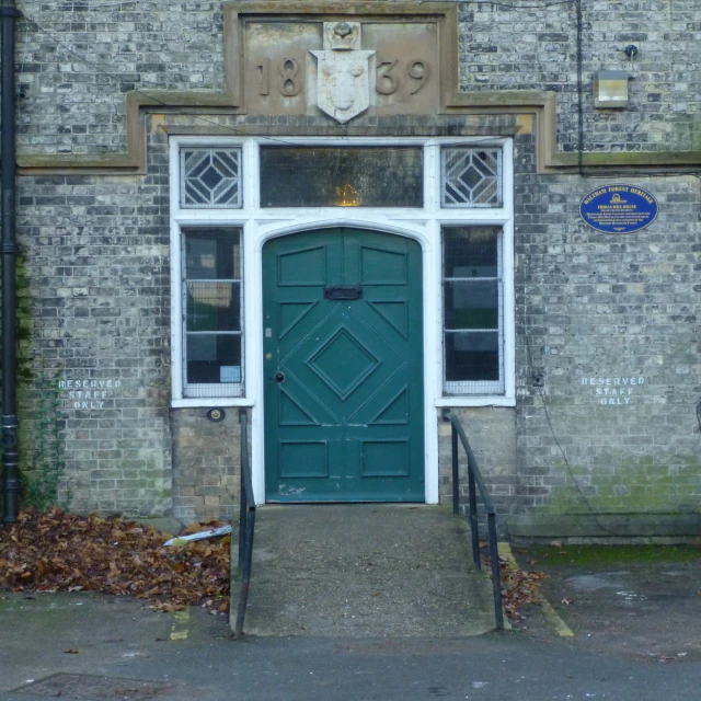 the door to the building has a large coat of arms