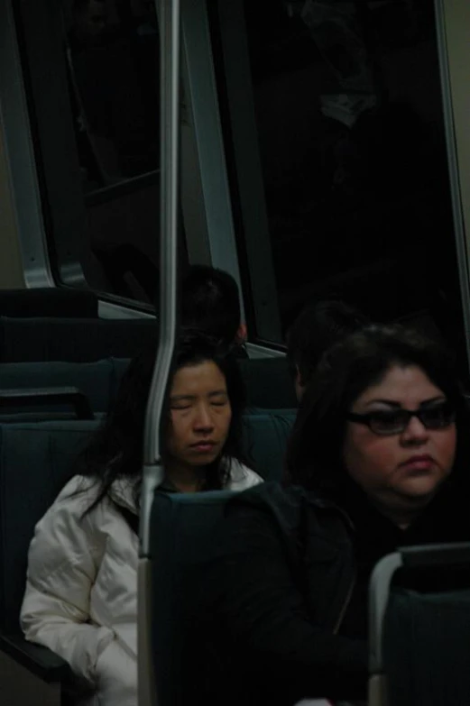 two women sit in the bus side by side
