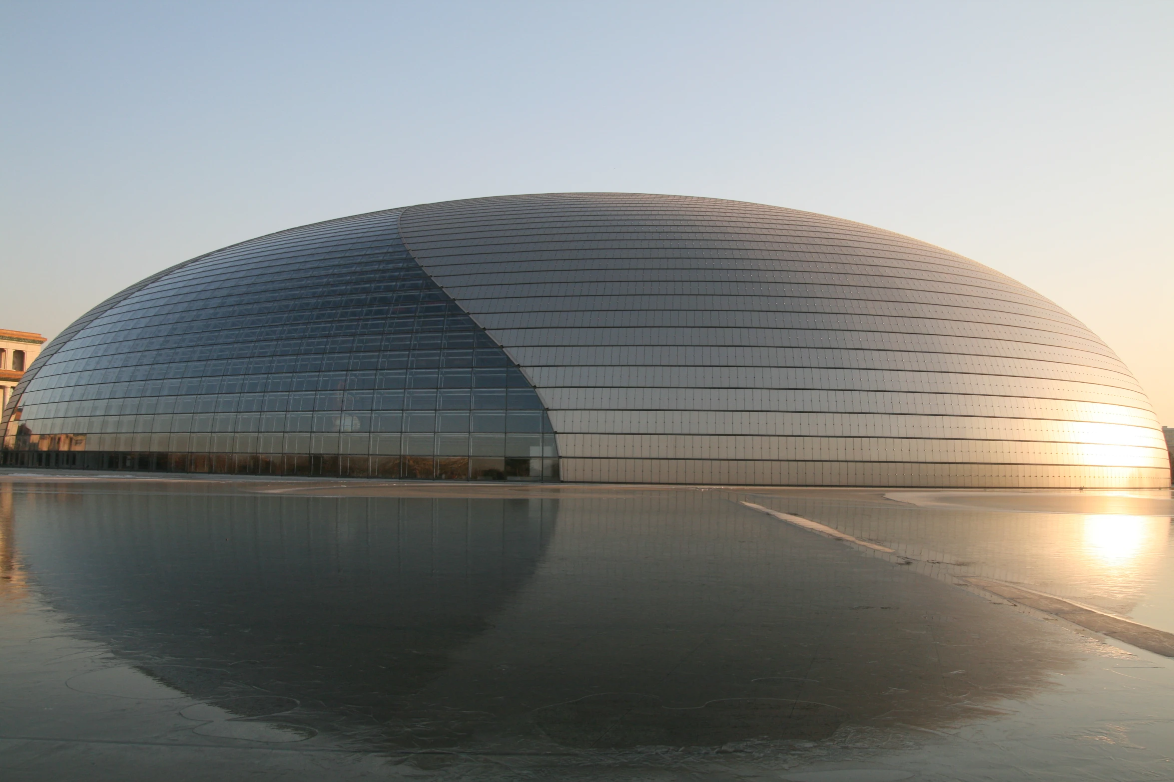 an exterior view of the sun rising over a dome structure