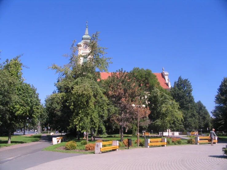 a clock tower and a group of benches in front of it