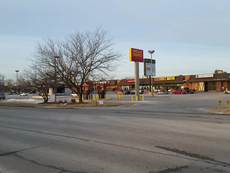 cars parked on the side of a road in front of a motel