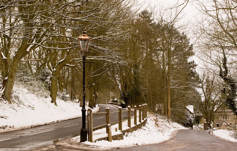 a road with a traffic sign and some snow