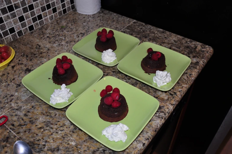 small slices of cakes sit on green plates