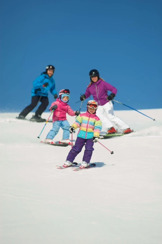 three people are standing in the snow with ski poles