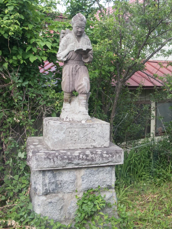 a statue in an overgrown park area is shown