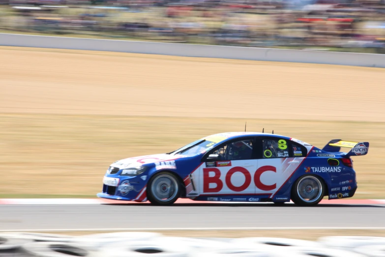 a car racing on a race track during the day