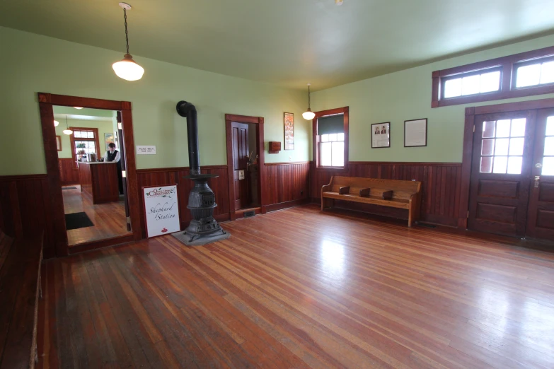 a large empty living room with wood floors