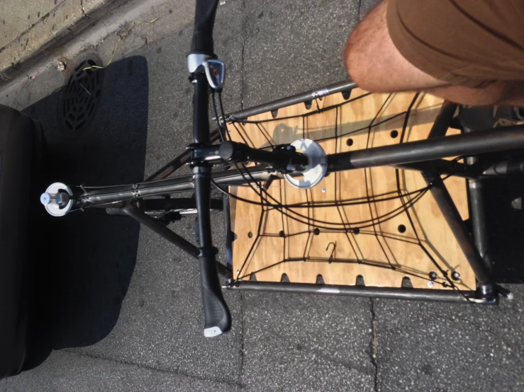 a bicycle is parked on a sidewalk near the road