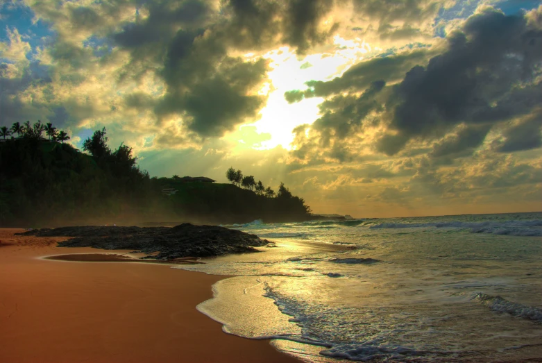 a sandy beach with waves and waves crashing on it