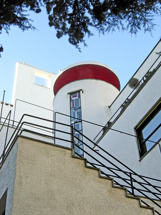 a red and white spiral staircase with a glass window