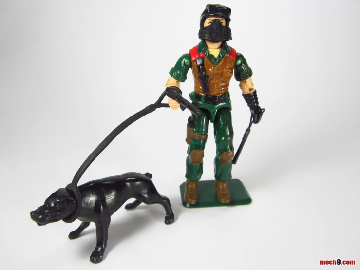 toy soldier with large toy black dog pulling leash