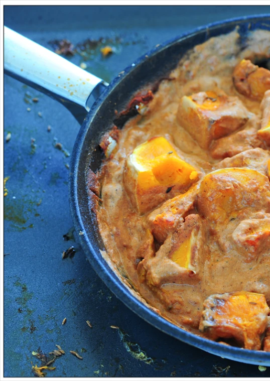 a pot filled with tofu and cheese sitting on top of a table