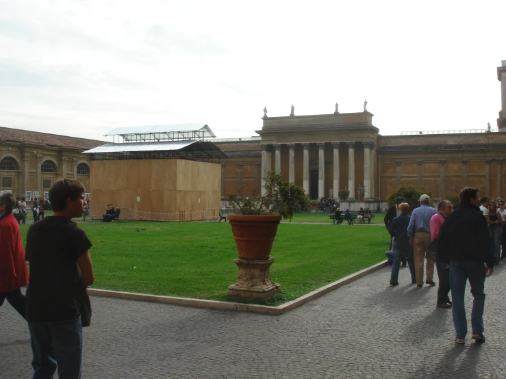 people are walking around in a square near buildings