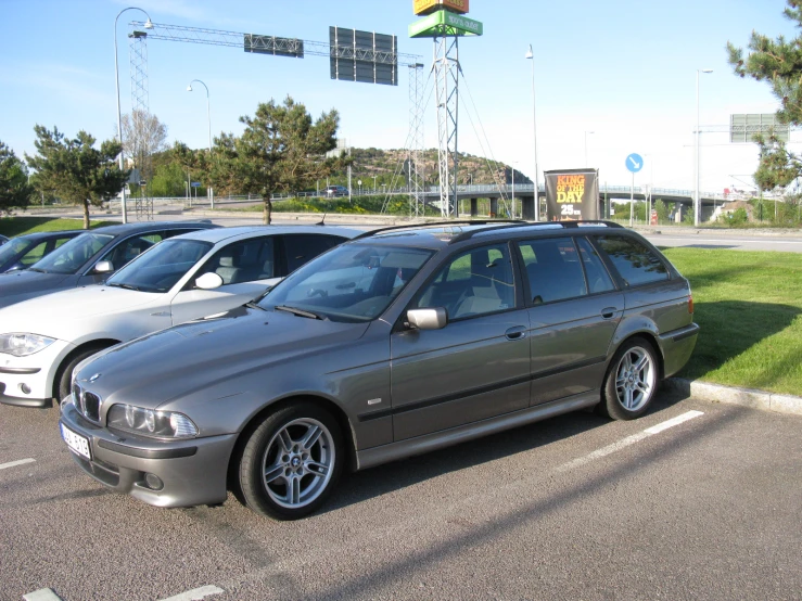 silver bmw parked in a lot on top of the grass