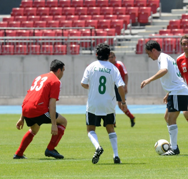 several men are playing soccer together in a field