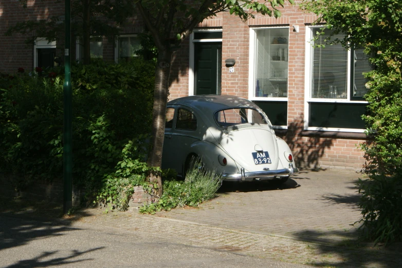 an old car parked next to a building