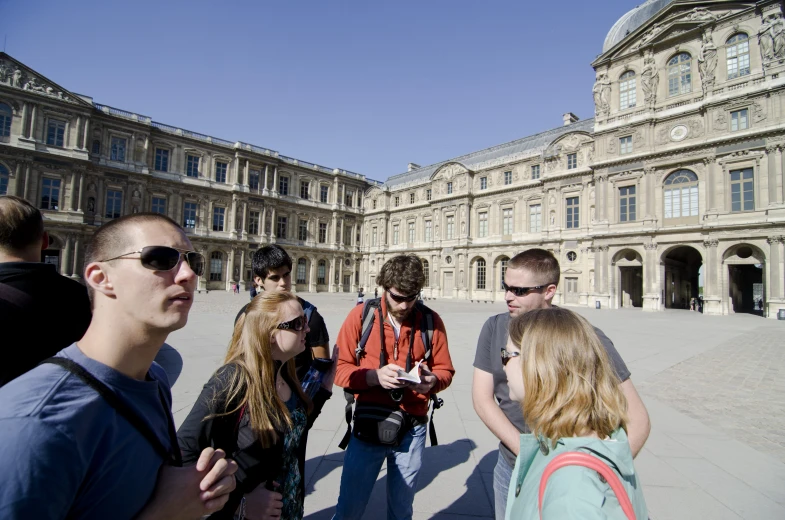 some people standing in front of a large building