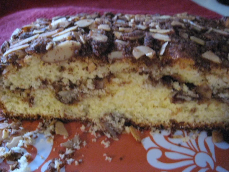 sliced of yellow cake with nuts on it on a red and white plate