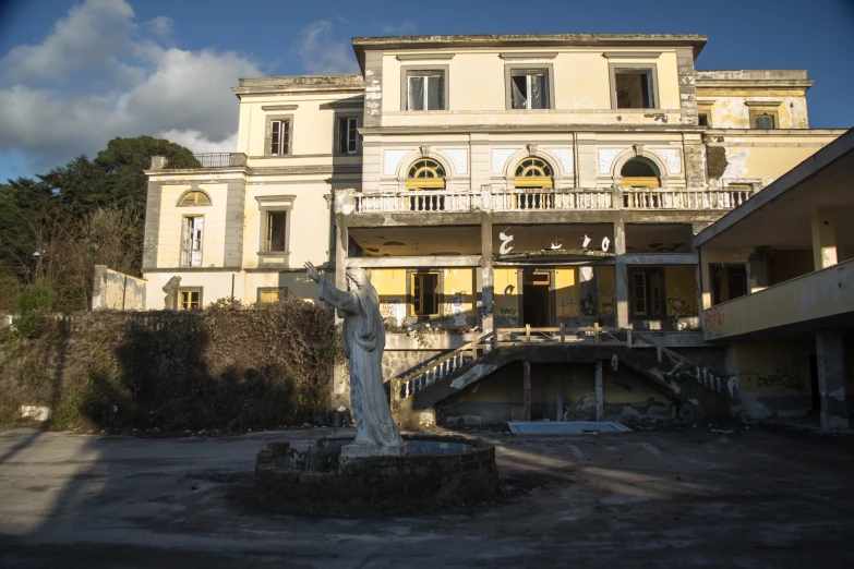 a statue in front of an old building