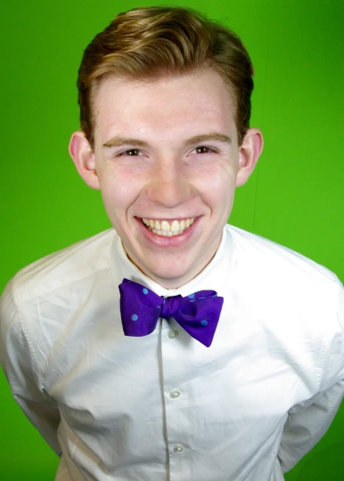 a young man wearing a purple bow tie