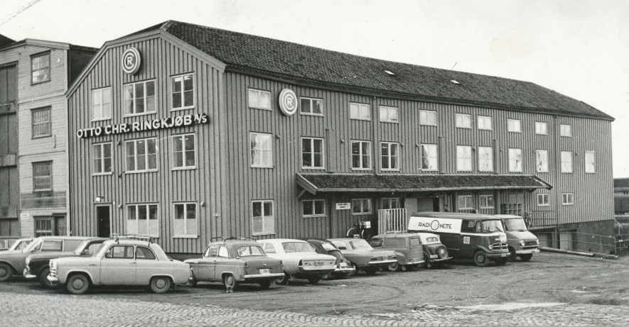 a line of cars parked outside of a large building