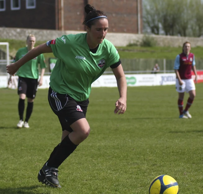 several women are playing soccer on the field