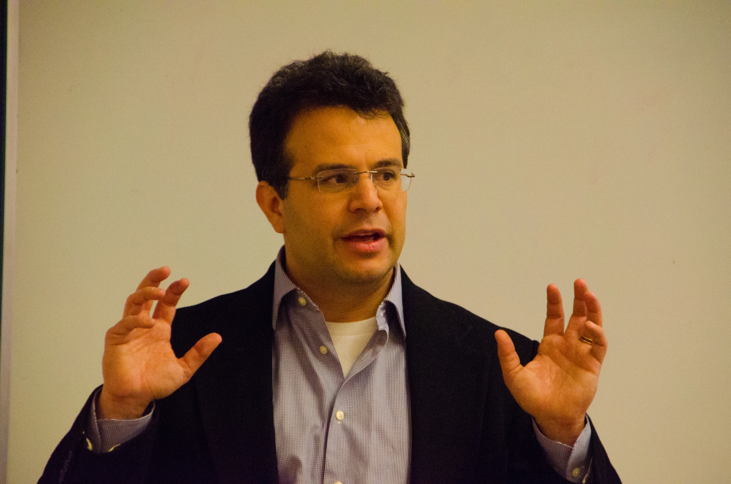 man making a gesture on stage with his hands