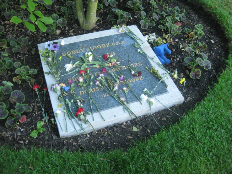 a cemetery has flowers and grass in the grass