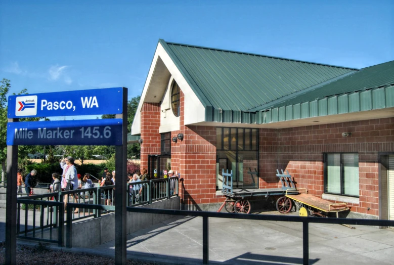 the people are waiting outside the station waiting to board