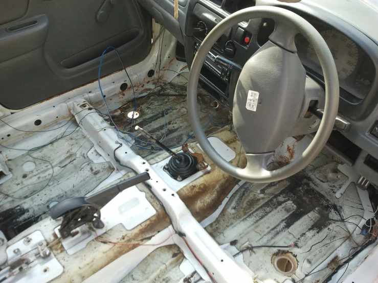 the inside of a vehicle with it's steering wheel and dash