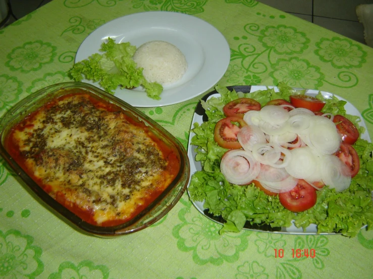 a square pizza sitting next to a green tablecloth