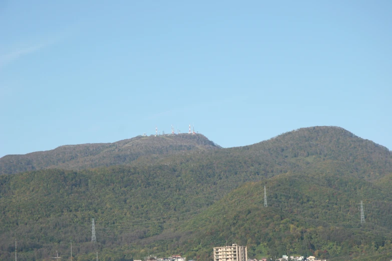 a mountain with hills and buildings in the foreground